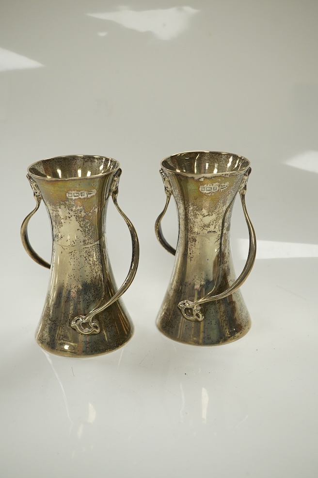 A pair of Edwardian Art Nouveau silver small vases, Walker & Hall, Sheffield, 1906, 10.1cm, 7.4oz. Condition - fair